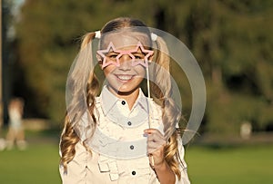 Little girl long hair hold star eyewear booth props, happy holidays concept