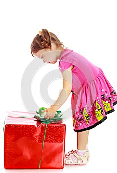 Little girl looking at a gift