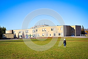 Little girl looking at her school from afar