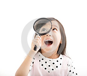 Little girl looking through magnifying glass