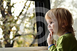 Little girl looking out window