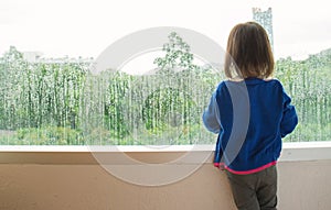 Little girl looking out of the window