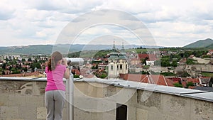 Little girl looking through sightseeing binoculars on Eger