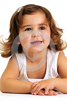 Little girl looking and smiling whilst leaning on