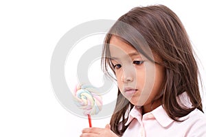 Little girl looking at sweet marshmallow candy