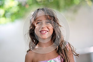 little girl looking to the camera and smiling