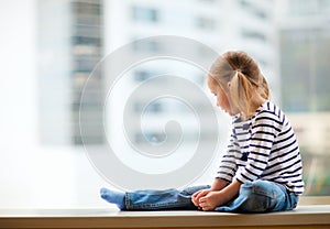 Little girl looking at window