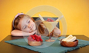 A little girl looking at zabaione dessert