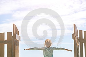 Little girl looks away in the background of the blue sky