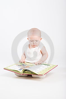 The little girl looks the children's book