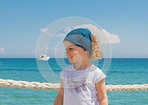 Little girl looks out to sea.