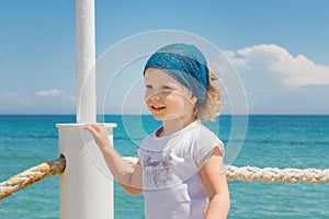 Little girl looks out to sea.