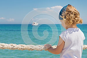 Little girl looks out to sea.