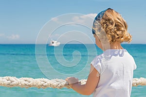 Little girl looks out to sea.