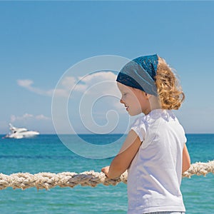 Little girl looks out to sea.