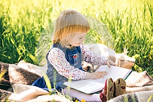 Little girl looks at pages of book