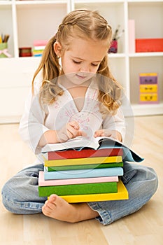 Little girl with lots of books