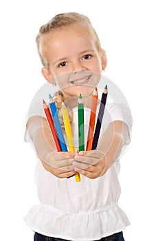 Little girl with lots of pencils - smiling photo