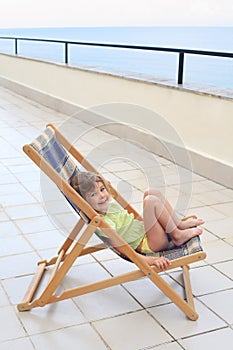 Little girl in lounge on veranda