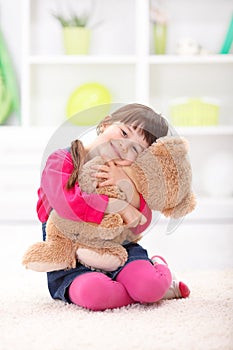 Little girl loving her plush bear