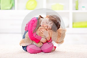 Little girl loving her plush bear