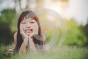 Little girl lying comfortably on the grass