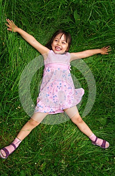 Little girl lying on grass