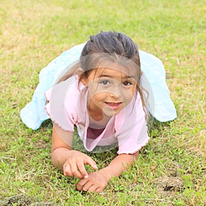 Little girl lying on grass