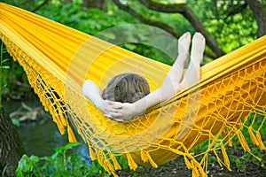 Little girl lying in a hammock