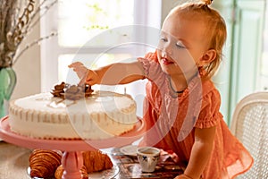 Little girl made Cup of tea with cake in kitchen.festive lunch.playing with kids