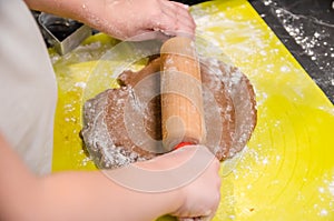 Little girl makes Christmas ginger cookies herself photo