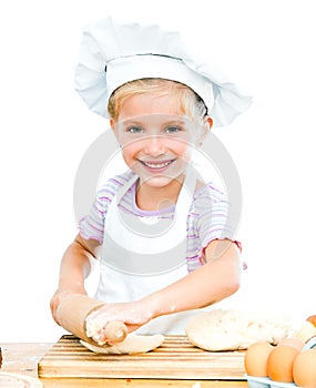 Little girl makes dough