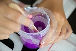 Little girl makes a homemade slime.