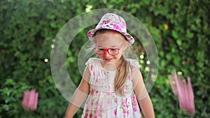 Little girl makes a salute from flowers of oleander