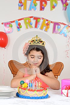 Little girl making birthday wish