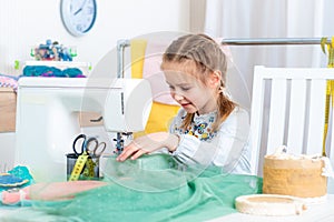 Little girl making crafts at sewing machine
