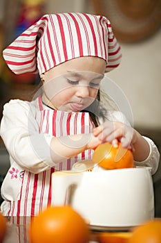 Little girl making fresh juice