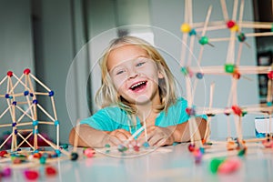 Little girl making geometric shapes, engineering and STEM