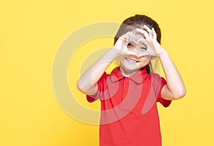 little girl making heart shape by hand