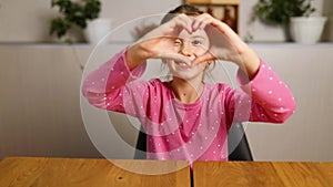 Little girl, making hearts from hands, love