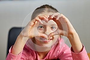 Little girl, making hearts from hands, love