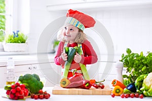 Little girl making salad for dinner