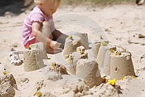 Little girl making sand castles