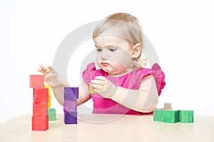 Little girl making towers