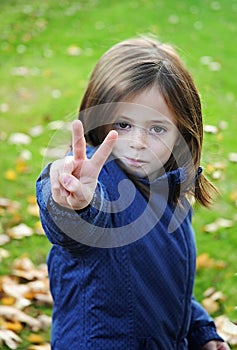 Little girl making victory sign