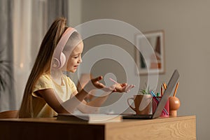 Little Girl Making Video Call On Laptop Learning Online Indoors