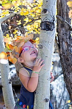 Little girl in maple leaves