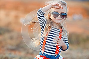 The little girl on the meadow in summer