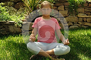little girl meditating in the garden