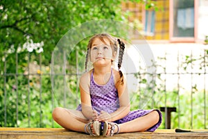 Little girl meditating outdoors. Relaxation